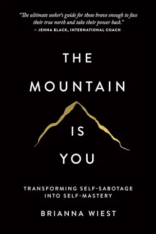 “The cover of The Mountain Is You by Brianna Wiest shows a textured beige background with a thin line-art drawing of a mountain. The title appears in large black letters above the illustration, and the subtitle reads, ‘Transforming Self-Sabotage Into Self-Mastery.’”